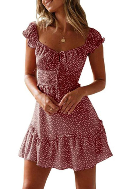 Woman wearing a sweetheart collar printed ruffled maxi dress in soft cotton with ruffle sleeves and a high waist design.