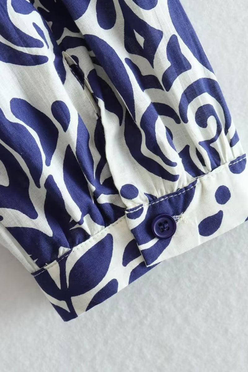 Close-up of blue floral lantern sleeve with button on Blue Floral Lantern Sleeves Midi Dress made from 100% polyester