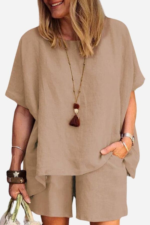 Woman wearing comfy linen-like shirt and shorts two-piece set in beige color