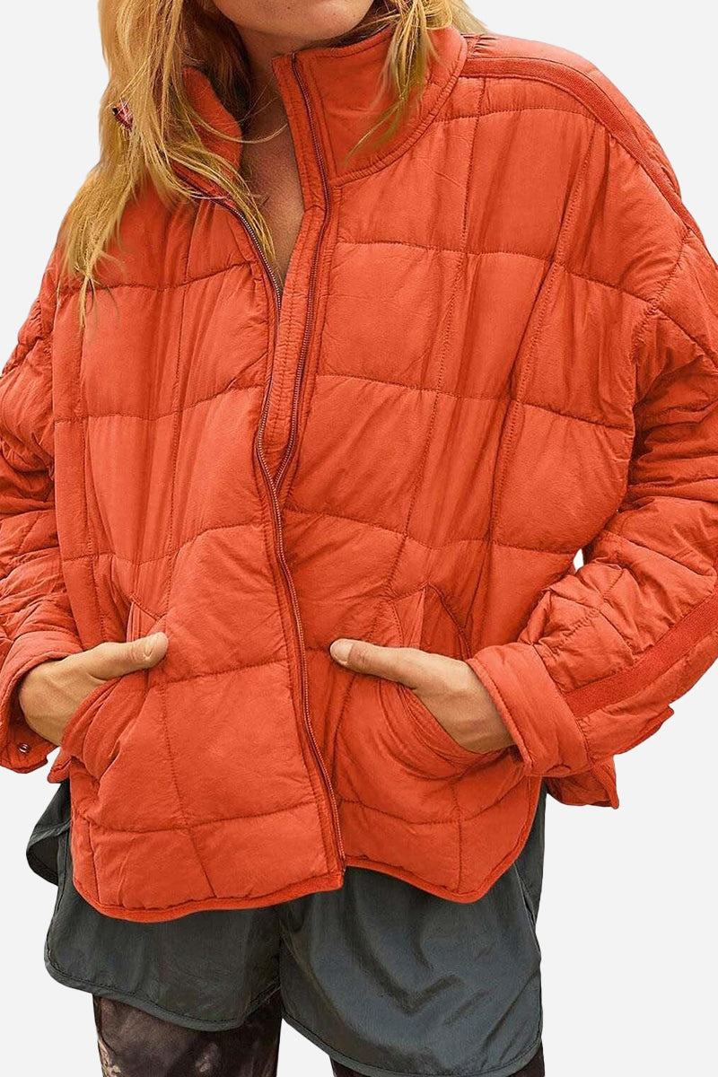 Lightweight puffer travel jacket packed compactly for versatile warmth and style