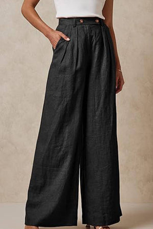 Black wide leg high waist trousers with elastic waistband and pockets worn with a white top