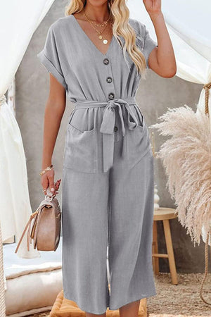 Grey V-neck lace-up pocket jumpsuit with tie waist and wide legs for a feminine look