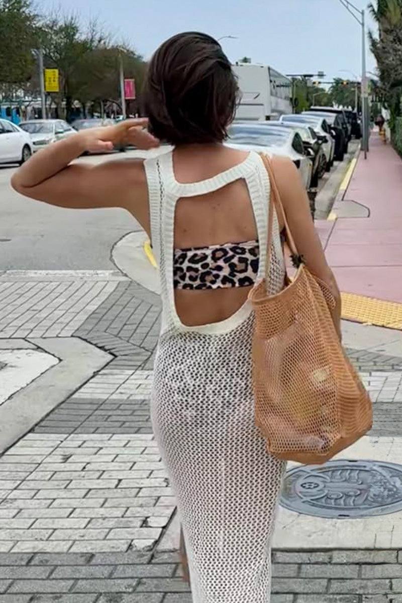 Woman carrying a beige Breezy Mesh Tote Bag on city sidewalk, showcasing lightweight, breathable polyester netting design.