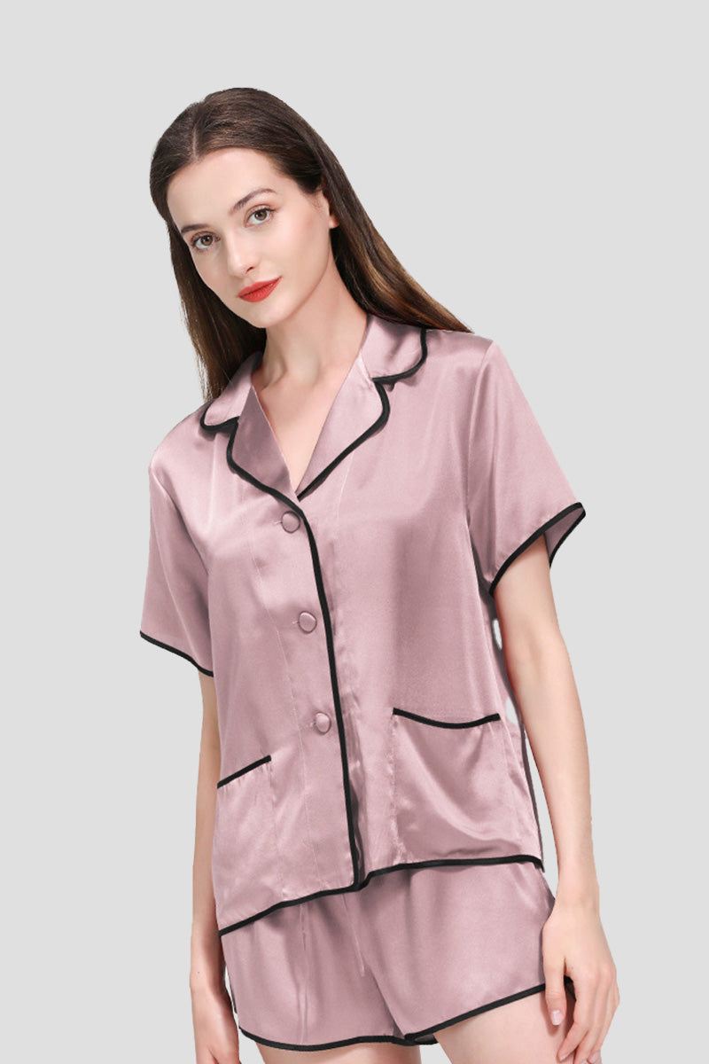 Woman wearing pink Mulberry Silk Hemd pajama set with black hems and shorts