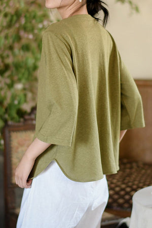 Back view of woman wearing olive green Linen Cotton Classy eco-friendly shirt with 3/4 sleeves and loose fit.