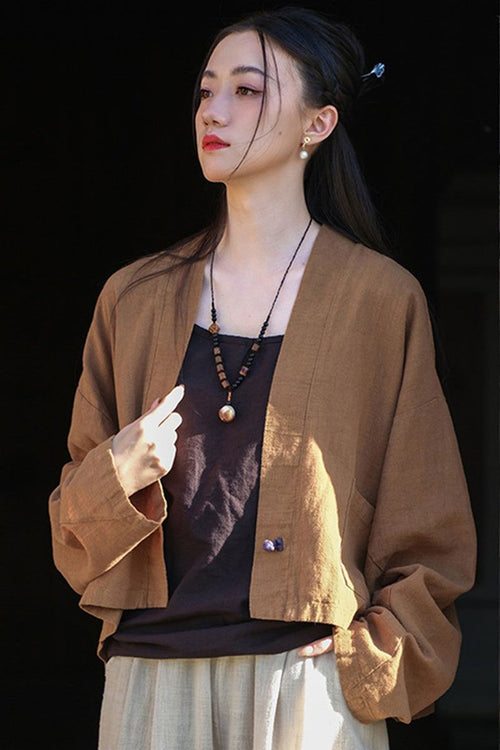 Woman wearing a brown ramie linen and cotton cardigan with relaxed fit and open front over a black top