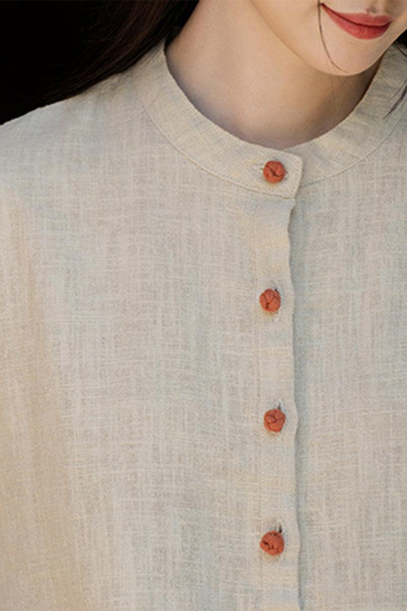 Close-up of woman wearing natural ramie linen and cotton blouse with wooden buttons and round neckline