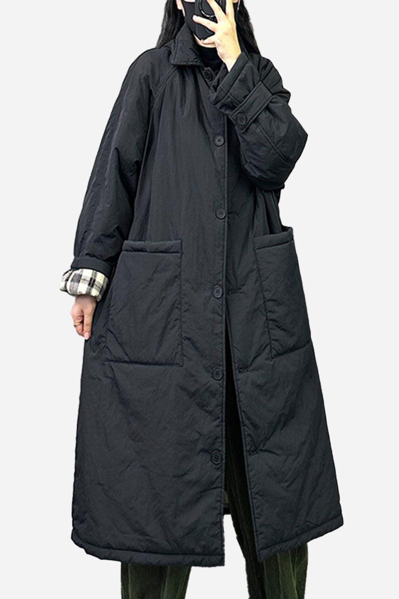 Plus size oversized black windbreaker parka with large pockets and long sleeves worn by model