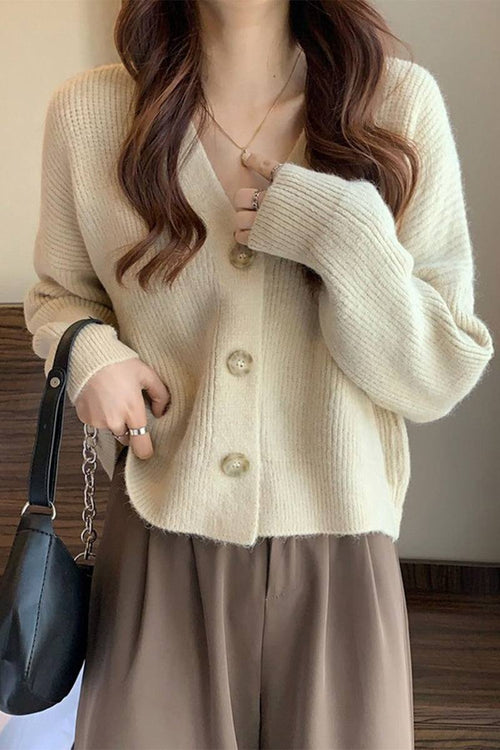 Casual loose boxy cardigan in beige with oversized fit and button front, styled with brown pants and black bag