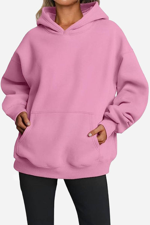 Pink oversized fleece-lined hoodie with front pocket and relaxed fit on model