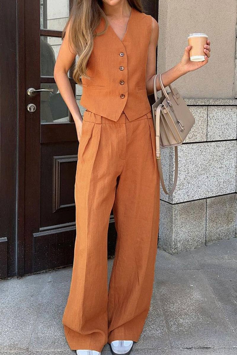 woman wearing eco chic linen blend rust-colored two-piece vest and wide-leg pants outfit holding coffee cup and beige handbag outdoors