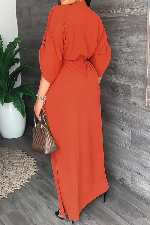 Woman wearing an orange All-Day Drape Dress with a cinched waist and adjustable sleeves, standing indoors with a handbag.