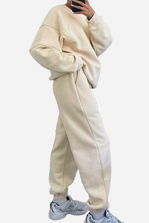 Beige comfy chic tracksuit set with relaxed fit, cozy polyester fabric, and elastic cuffs paired with white sneakers.