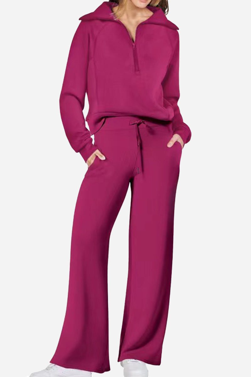 Woman wearing a magenta Loungewear Buttersoft Tracksuit Set with zip-up top and wide-leg pants in cozy, soft fabric.
