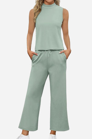 Cotton Chic Sleeveless two-piece set in soft green polyester-cotton blend with sleeveless top and wide-leg pants with pockets