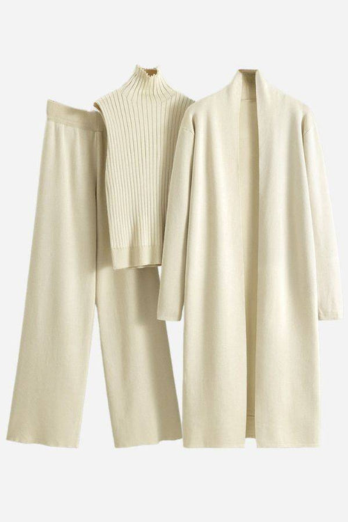 Beige one size fits all three-piece collection with ribbed turtleneck, wide-leg pants, and long open cardigan.