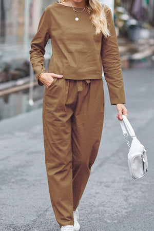 Woman wearing brown cotton relaxed two-piece Casual Chic Duo outfit walking outdoors carrying white handbag