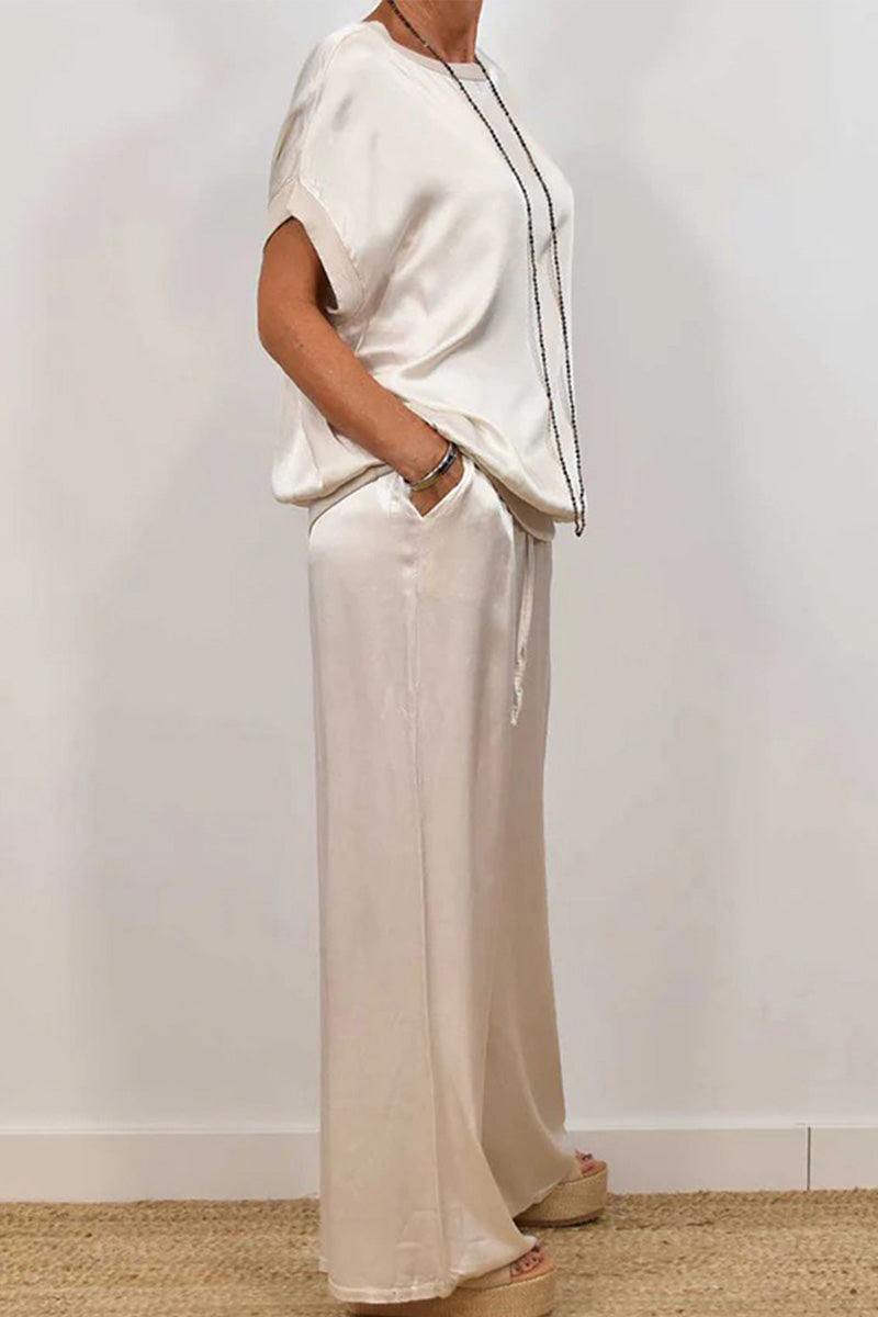 Silken Escape Satin Two-Piece Set featuring relaxed fit satin top and wide-leg pants with pockets in soft cream color