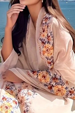 Lightweight beige embroidered travel-must shawl with floral design worn as a versatile wrap
