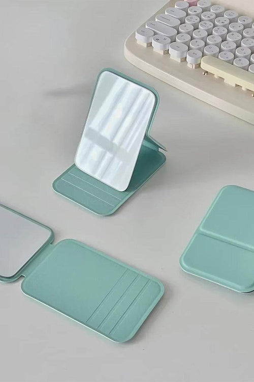 Compact travel pocket mirror with durable PU leather case in pastel green, perfect for purse or pocket use.