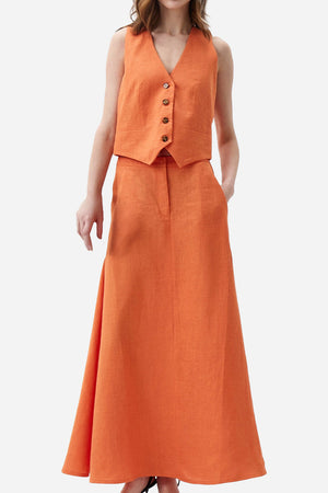 Woman wearing cotton-linen blend Mediterranean sunset orange two-piece with sleeveless vest and flowing skirt