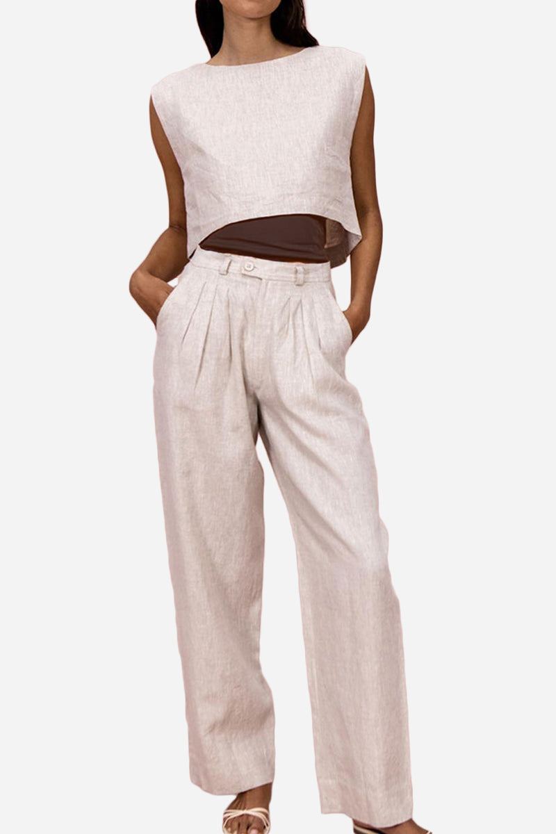 Woman wearing breathable cotton-linen blend two-piece summer outfit with cropped top and wide-leg pants, beige color