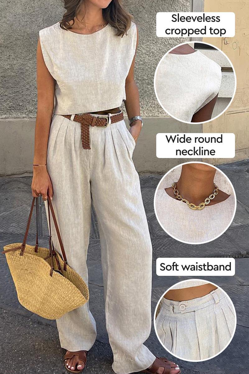 Woman wearing cotton-linen blend sleeveless cropped top and wide-leg pants with soft waistband, accessorized with brown belt and straw bag