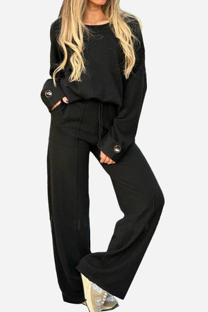 black comfortable travel-ready two-piece set with wide-leg pants and button-cuff sweater