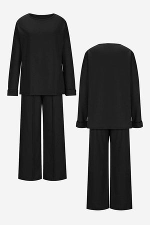 Black comfortable travel-ready two-piece set with relaxed fit long-sleeve top and wide-leg pants, wrinkle-resistant fabric.