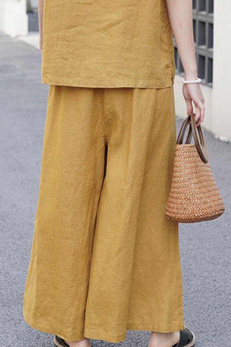 Mustard yellow wide-leg pants made from 100% linen for breathable, comfortable wear.