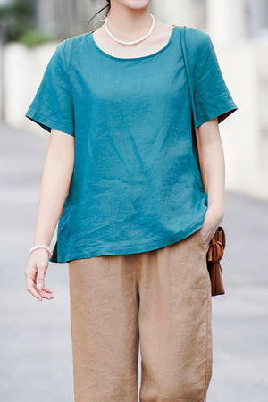 woman wearing breathable 100 pure linen teal short sleeve shirt with brown pants