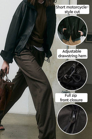 Black sheepskin leather jacket with short motorcycle-style cut, adjustable drawstring hem, and full zip front closure.