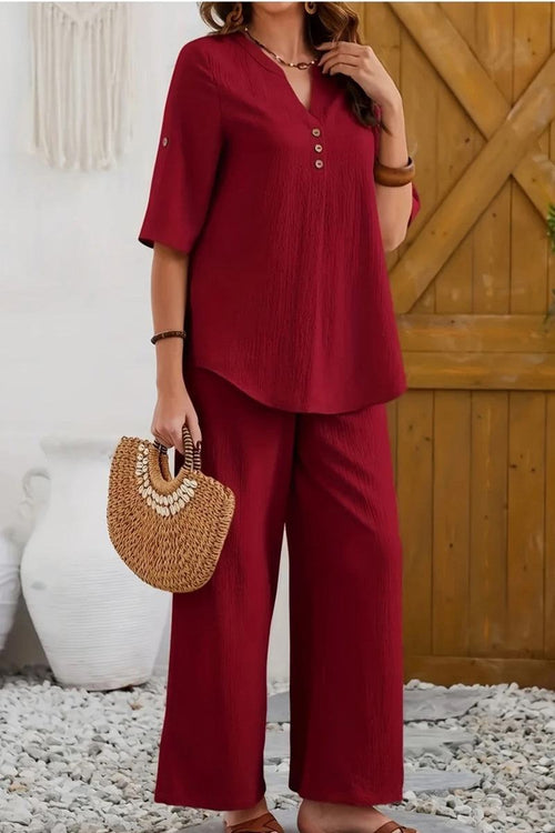 Red wrinkle-free wide leg pants and matching button-front top travel set with 3/4 sleeves and casual fit.