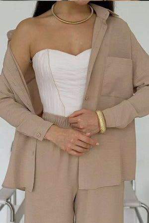 Relaxed fit wide-leg two-piece set in beige with wrinkle-resistant fabric and casual styling.