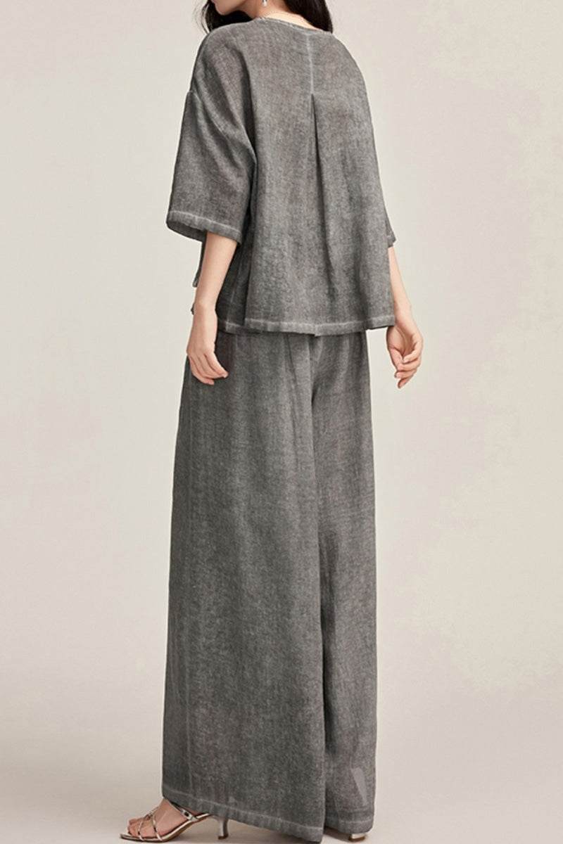 Back view of woman wearing 100% linen stone-washed loose-fit gray top and wide-leg pants set