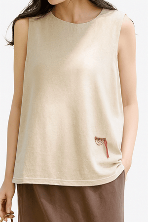 Dandelion Fields Cotton Linen sleeveless top in soft beige with relaxed fit and small embroidered detail.