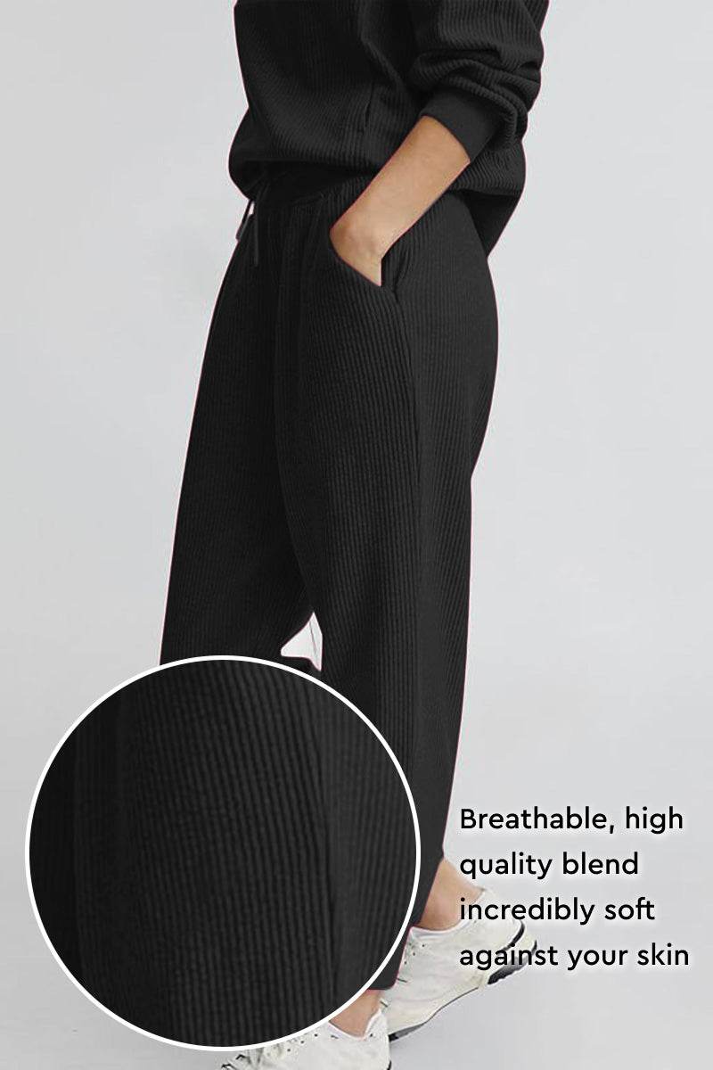 Unisex half-zip pullover and sweatpants set in breathable soft black polyester blend