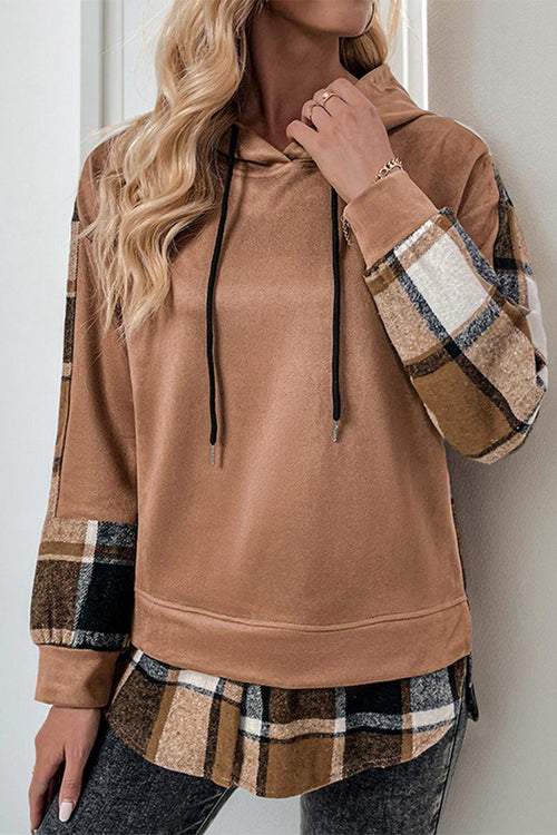 Woman wearing a cozy brown Countryside Layered Hoodie with plaid accents on sleeves and hem, styled with gray pants.