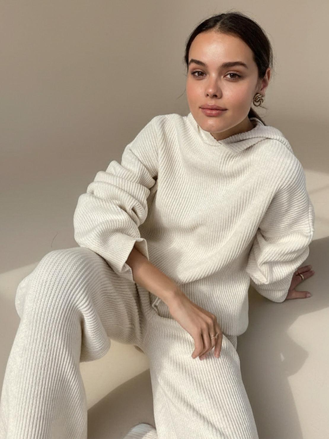 woman wearing white waffle-knit two-piece loungewear set with hoodie and pants sitting on floor