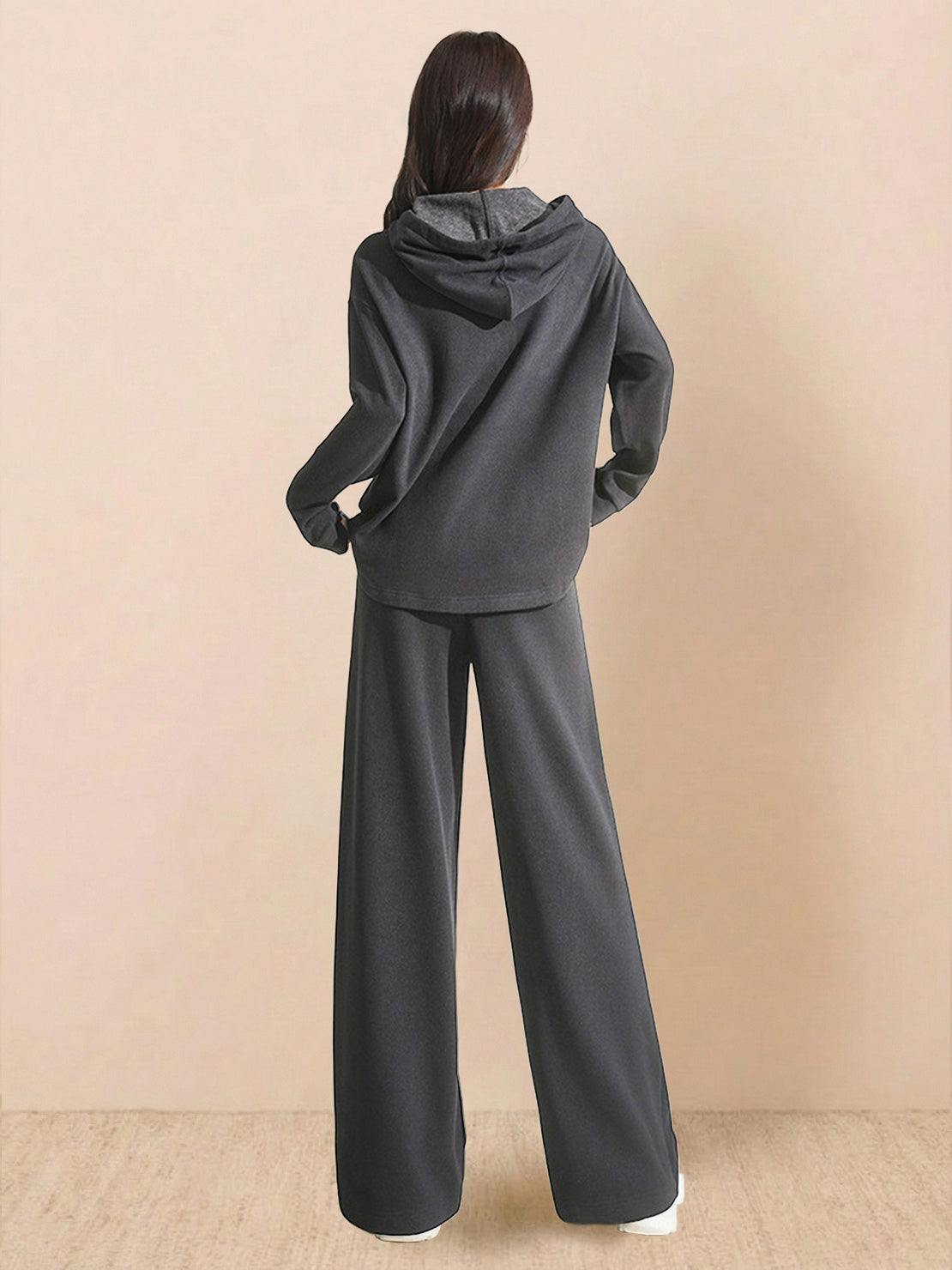 Woman wearing charcoal gray lyocell-blend hooded set with wide-leg pants, back view