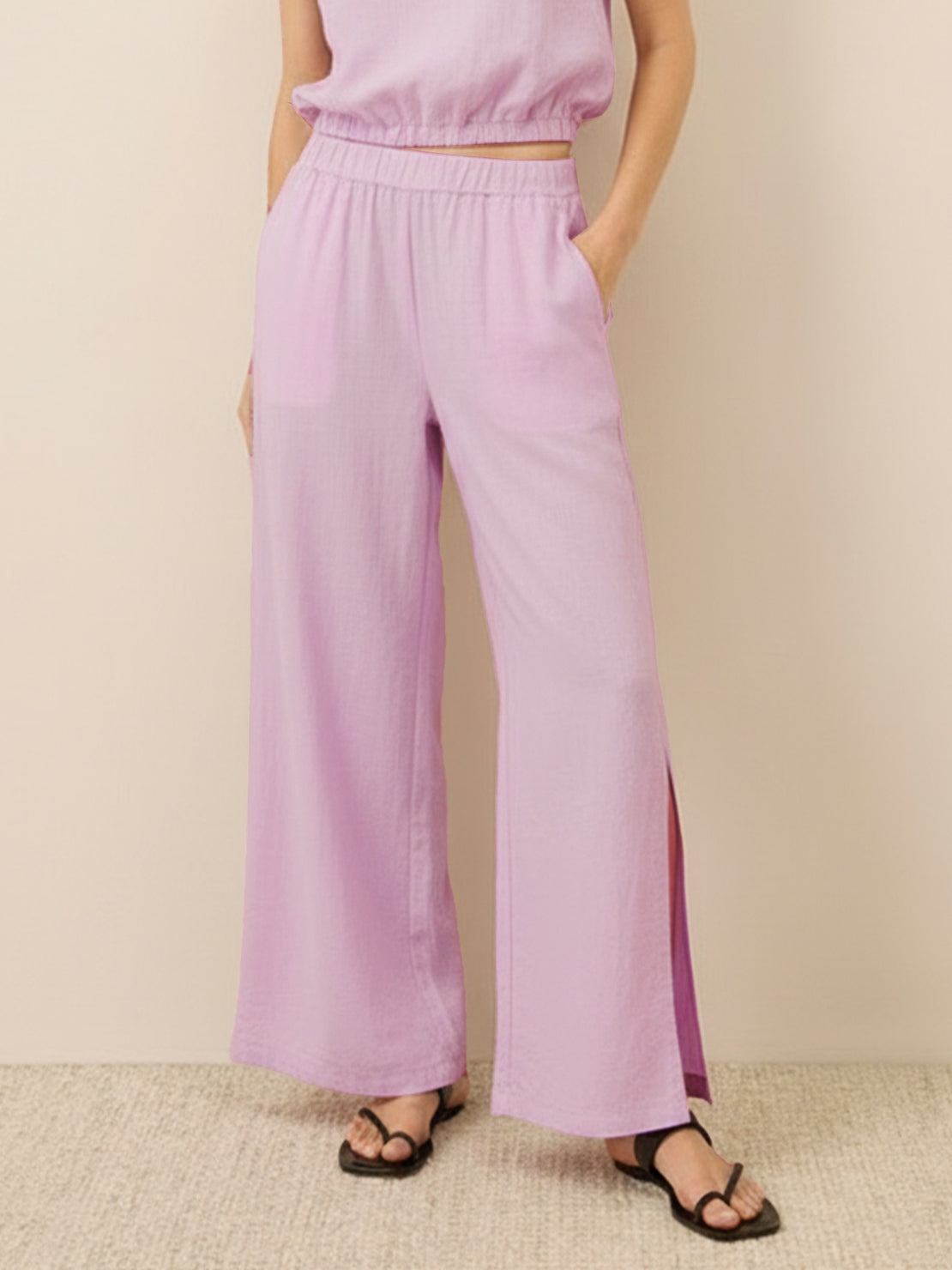 Lightweight linen-blend set with sleeveless top and wide-leg pants featuring elastic waistband and side slits