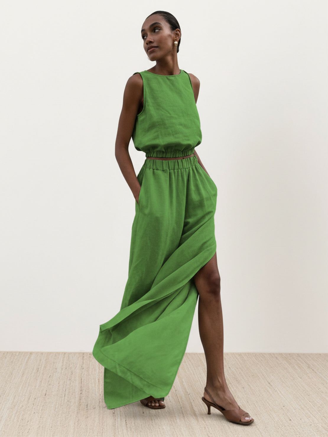Lightweight linen-blend set with sleeveless top and wide-leg pants featuring elastic waistband and side slits for breathable comfort