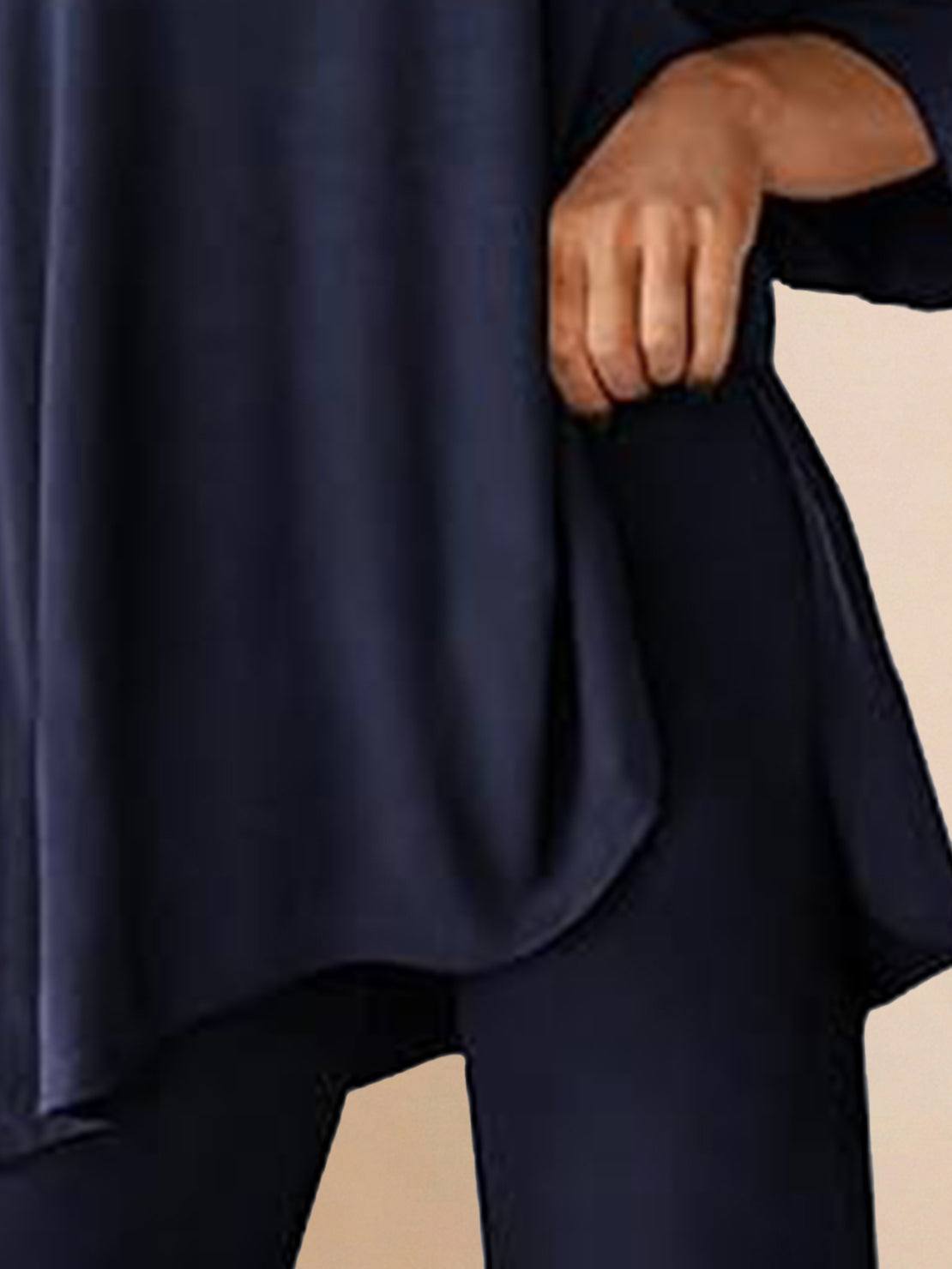 Woman wearing oversized long-line loungewear set with short-sleeve pullover and wide-leg pants