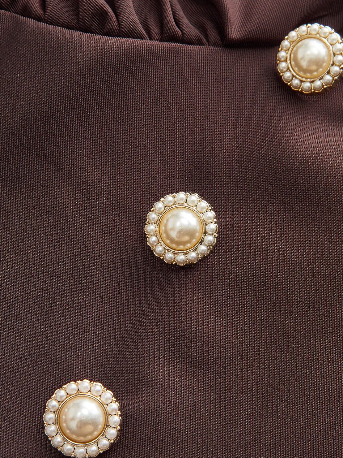 Woman wearing slimming V-neck midi dress with button-front and ruffle cuffs