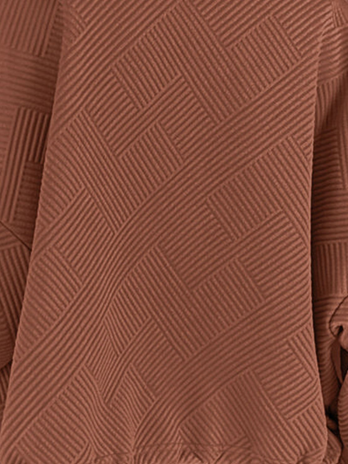 Cropped textured baseball jacket with full zipper and elastic cuffs, styled for casual wear