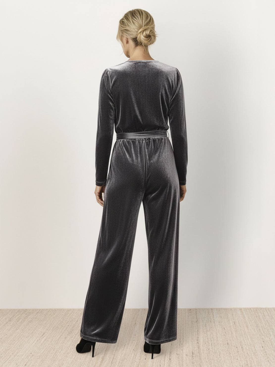 Deep V-neck velvet suit with long sleeves, removable waist tie, and wide-leg pants in structured, flexible fabric
