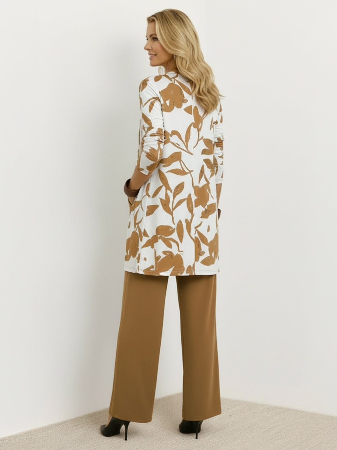 woman wearing open-front three-piece co-ord with longline cardigan, tank top, and wide-leg trousers