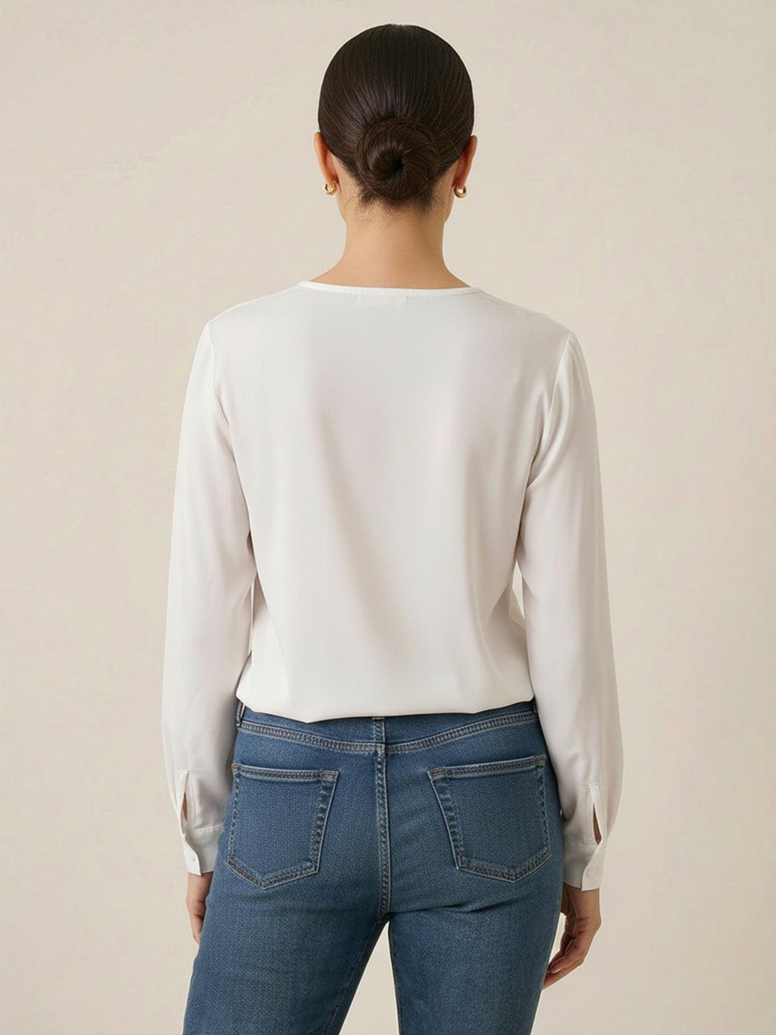 White pleated V-neck long-sleeve blouse with button cuffs and relaxed fit