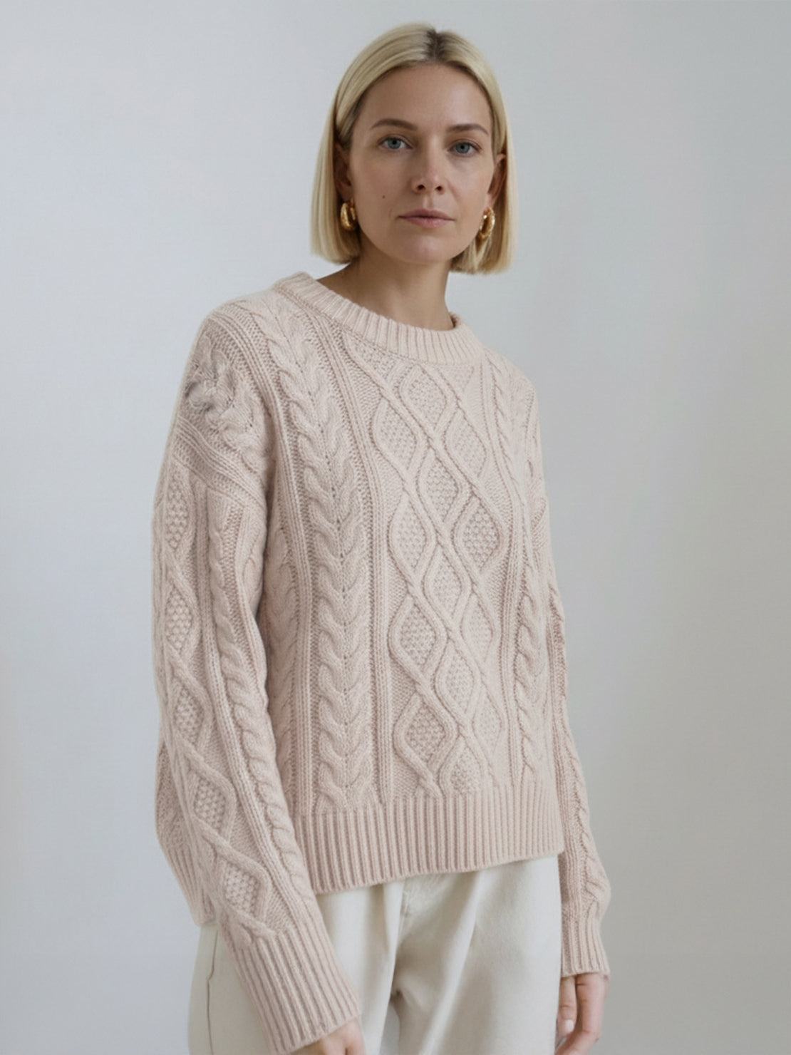 Oversized cable-knit crewneck sweater with dropped shoulders and ribbed trim