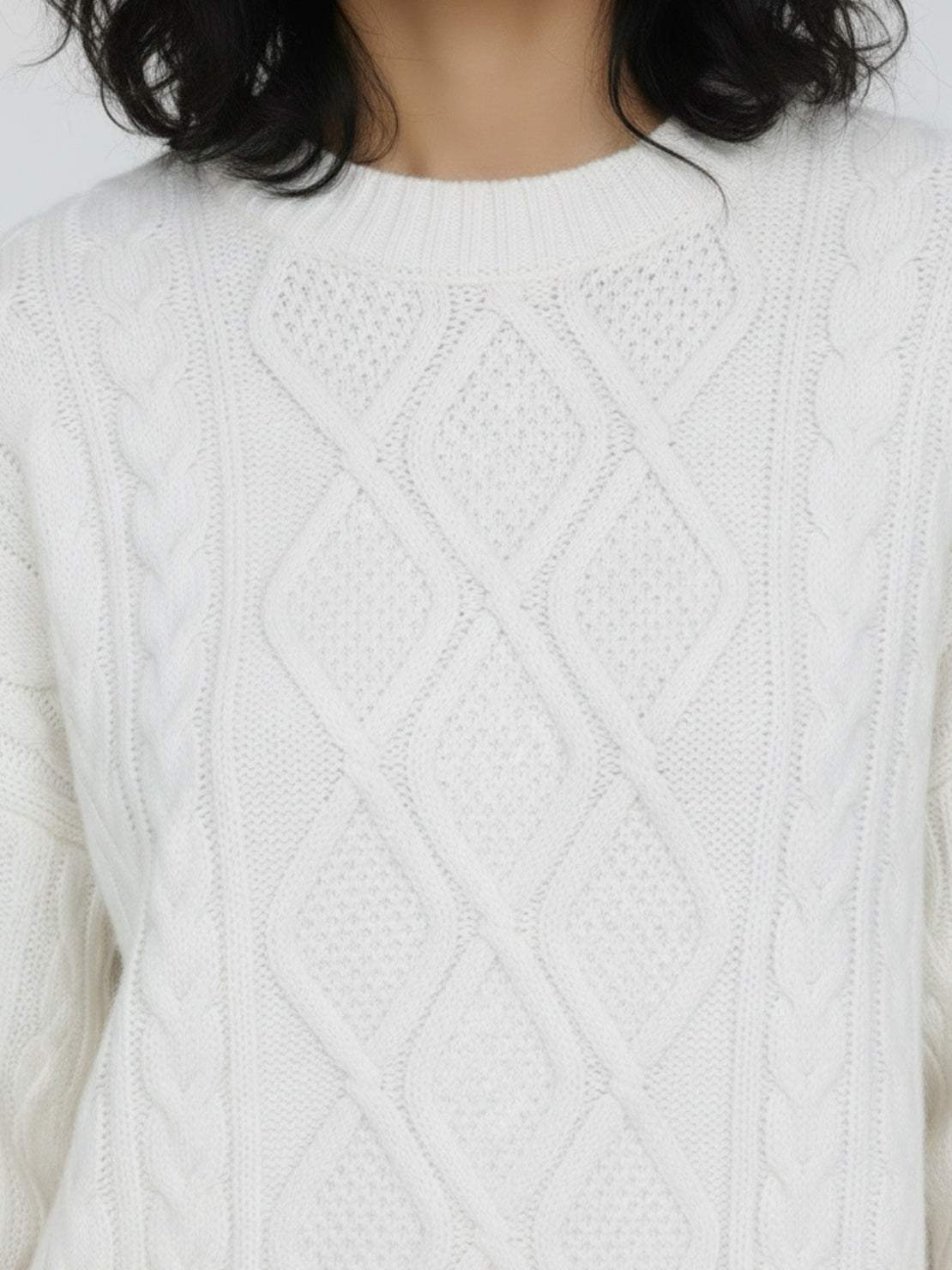 Oversized cable-knit crewneck sweater with dropped shoulders and ribbed trims